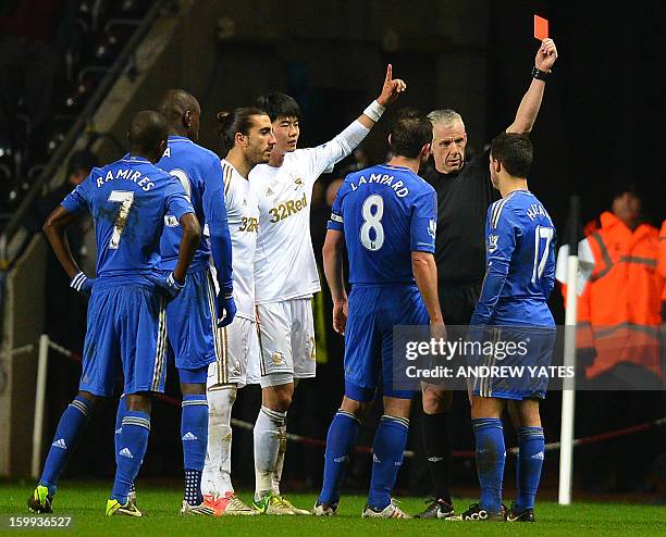 Chelsea's Belgium midfielder Eden Hazard is sent off by referee Chris Foy after an incident involving a ballboy during the English League Cup...