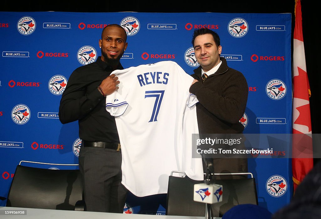 Jose Reyes of the Toronto Blue Jays holds up his jersey at a press ...