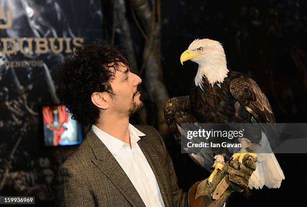 Actor and friend of the Roger Dubuis brand, Tomer Sisley holds an eagle as he visits the booth during the 23rd Salon International de la Haute...