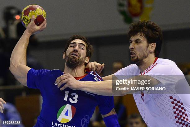 France's centre back Nikola Karabatic vies with Croatia's right back Marko Kopljar during the 23rd Men's Handball World Championships quarterfinal...