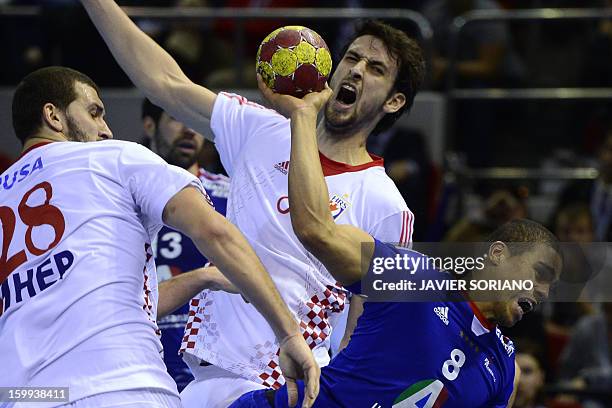 France's centre back Daniel Narcisse shoots past Croatia's right back Marko Kopljar and Croatia's pivot Zeljko Musa during the 23rd Men's Handball...