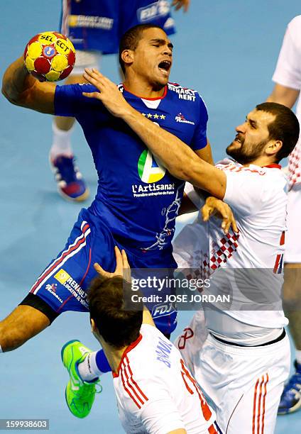 France's centre back Daniel Narcisse vies with Croatia's pivot Zeljko Musa during the 23rd Men's Handball World Championships quarterfinal match...