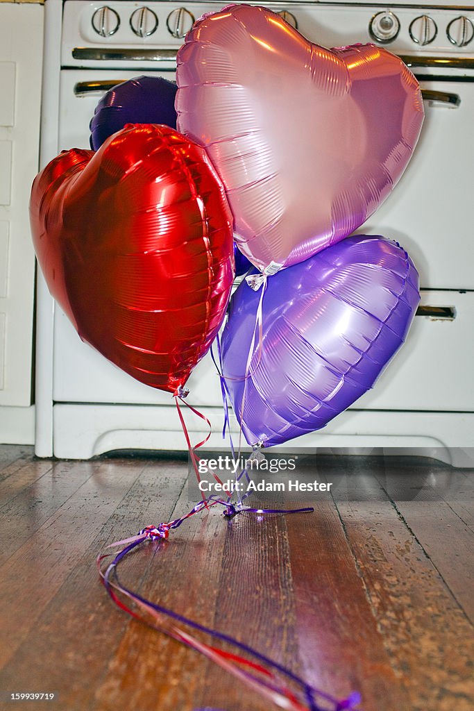 Colorful balloons inside the kitchen of a home.