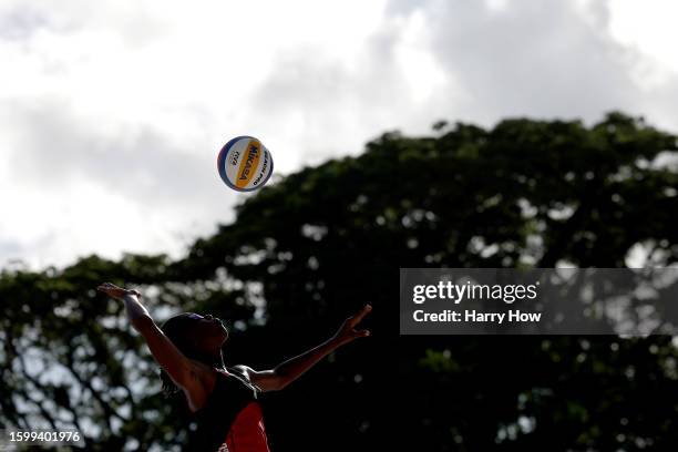 Fe Roberts of Team Trinidad and Tobago serves against Stephanie Joel and Eleno Moule of Team Vanuatu in the Women's Beach Volleyball 9 - 12...