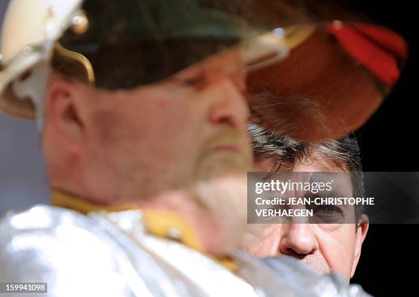 French far-left Parti de Gauche party's leader Jean-Luc Melenchon is pictured beside an ArcelorMittal unionist of Florange plant during a meeting on...