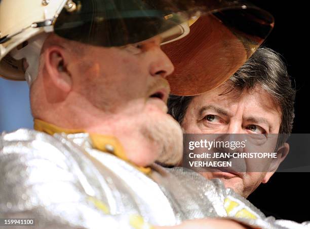 French far-left Parti de Gauche party's leader Jean-Luc Melenchon is pictured beside an ArcelorMittal unionist of Florange plant during a meeting on...