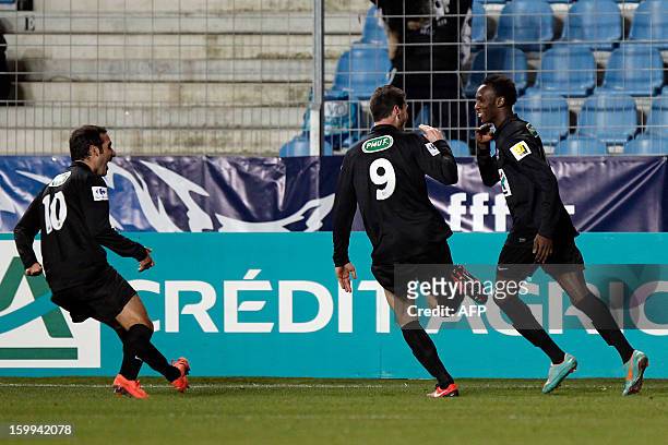 S forward Alassane N'Diaye is congratulated by teammates after scoring a goal during the French Cup football match CA Bastia vs Brest in the Armand...