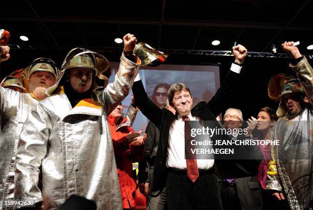 French far-left Parti de Gauche party's leader Jean-Luc Melenchon raises his fists beside ArcelorMittal unionists, on January 23, 2013 in Metz,...
