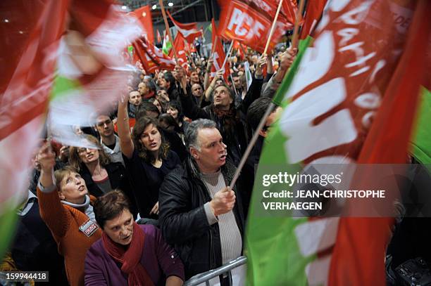 Supporters of French far-left Parti de Gauche party and French Communist Party wave flags during a meeting launching the French left-wing Front de...