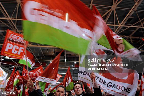 Supporters of French far-left Parti de Gauche party and French Communist Party wave flags during a meeting launching the French left-wing Front de...