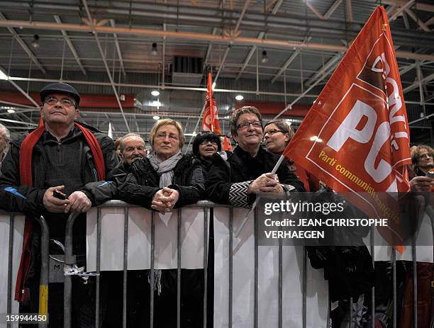 Supporters of French Communist Party listen during a meeting launching the French left-wing Front de Gauche party's campaign entitled "Alternative to...