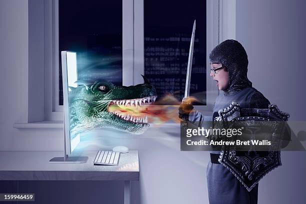 boy dressed as knight confronts a computer dragon - fantasy game stock pictures, royalty-free photos & images