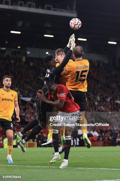 Manchester United goalkeeper Andre Onana clashes with Craig Dawson of Wolverhampton Wanderers during the Premier League match between Manchester...