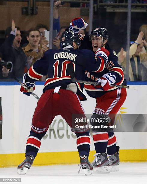 Marian Gaborik of the New York Rangers scores his third goal of the game in overtime to defeat the Boston Bruins, and is joined by Ryan McDonagh at...