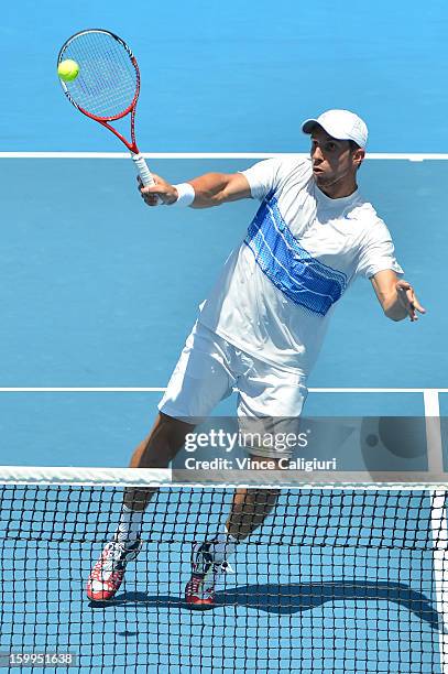 Igor Sijsling of the Netherlands plays a forehand in their doubles semifinal match with Robin Haase of the Netherlands against Marcel Granollers of...