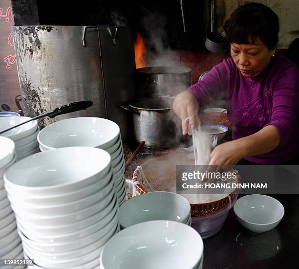 To go with "Vietnam-food-culture,FEATURE" by Cat Barton This picture taken on January 10, 2013 shows an employee placing pho noodles into bowls at...