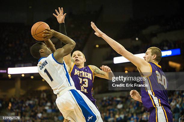 Austin Chatman of the Creighton Bluejays shoots over Marc Sonnen and Jake Koch of the Northern Iowa Panthers during their game at the CenturyLink...