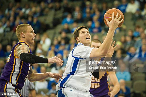 Doug McDermott of the Creighton Bluejays takes the ball to the basket against Marc Sonnen of the Northern Iowa Panthers during s game at the...