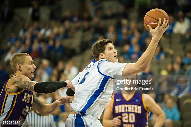 Doug McDermott of the Creighton Bluejays takes the ball to the basket against Marc Sonnen of the Northern Iowa Panthers during their game at the...