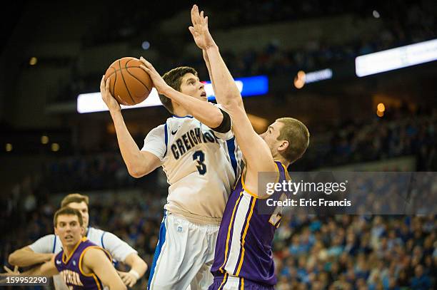 Doug McDermott of the Creighton Bluejays goes up for a shot over Jake Koch of the Northern Iowa Panthers during their game at the CenturyLink Center...