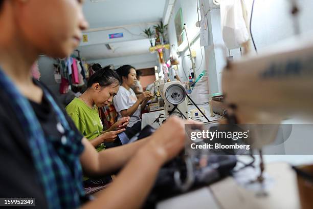 Tailors make clothes at a workshop in Bangkok, Thailand, on Wednesday, Jan. 23, 2013. Prime Minister Yingluck Shinawatra's government last month...