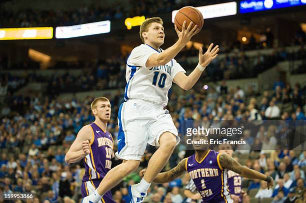 Grant Gibbs of the Creighton Bluejays drives to the hoop against Seth Tuttle and Deon Mitchell of the Northern Iowa Panthers during their game at the...