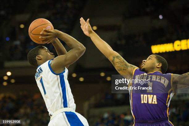 Austin Chatman of the Creighton Bluejays shoots against Deon Mitchell of the Northern Iowa Panthers during their game at the CenturyLink Center on...