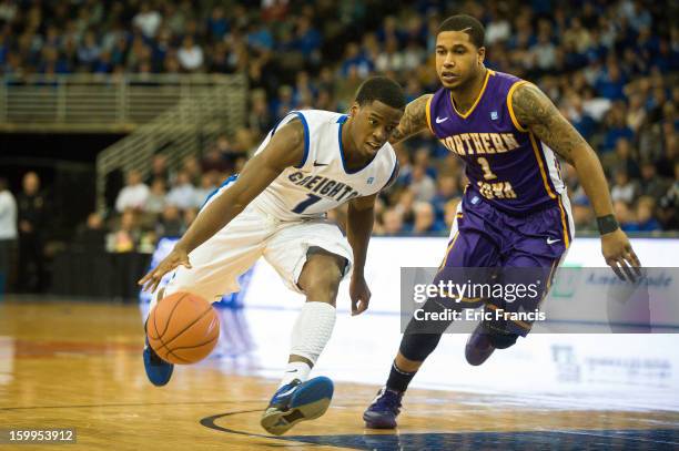 Austin Chatman of the Creighton Bluejays drives against Deon Mitchell of the Northern Iowa Panthers during their game at the CenturyLink Center on...