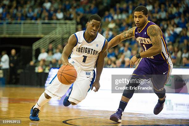 Austin Chatman of the Creighton Bluejays drives against Deon Mitchell of the Northern Iowa Panthers during their game at the CenturyLink Center on...