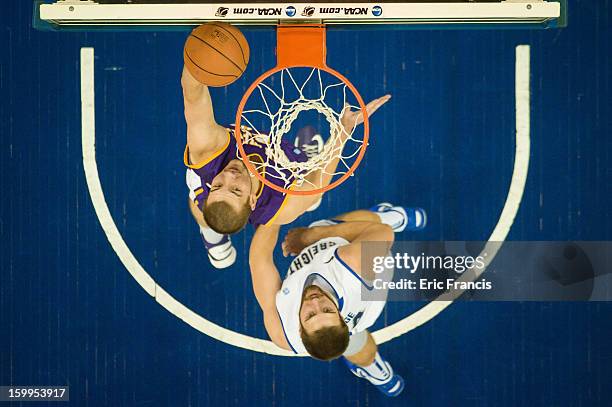 Jake Koch of the Northern Iowa Panthers shoots past Ethan Wragge of the Creighton Bluejays during a game at the CenturyLink Center on January 15,...