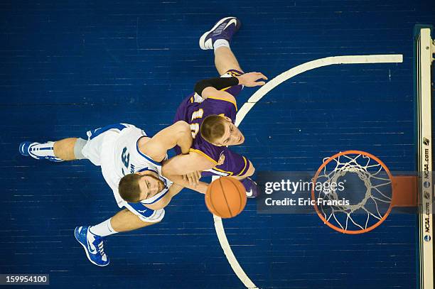 Seth Tuttle of the Northern Iowa Panthers and Ethan Wragge of the Creighton Bluejays battle for a rebound during a game at the CenturyLink Center on...