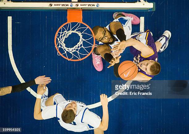 Gregory Echenique and Grant Gibbs of the Creighton Bluejays battle with Seth Tuttle and Marc Sonnen of the Northern Iowa Panthers for a rebound...