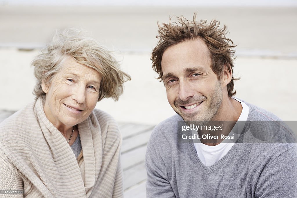 Senior woman and adult son on the beach, portrait
