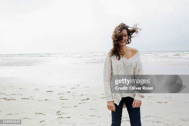 laughing brunette woman on the beach - pretty brunette woman - fotografias e filmes do acervo