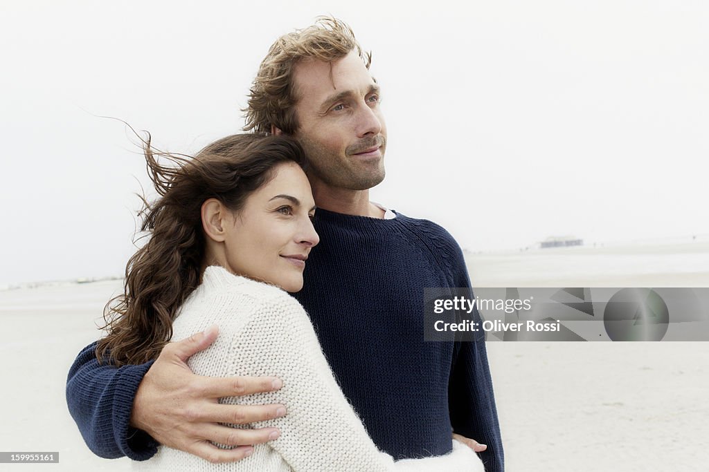 Couple hugging on the beach