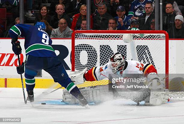 Zack Kassian of the Vancouver Canucks goes to his backhand to beat Miikka Kiprusoff of the Calgary Flames for the shootout-winning goal during their...