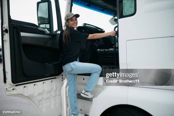 semi-truck driver climbing into the truck cab - trucker stock pictures, royalty-free photos & images