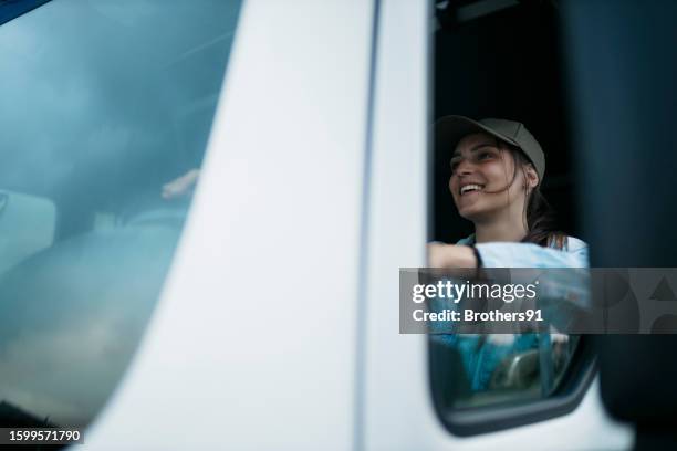 beautiful young woman driving a semi-truck - semi truck stock pictures, royalty-free photos & images