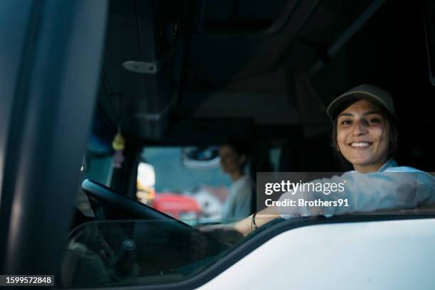 portrait of a beautiful young woman driving a delivery truck - trucker hat stock pictures, royalty-free photos & images