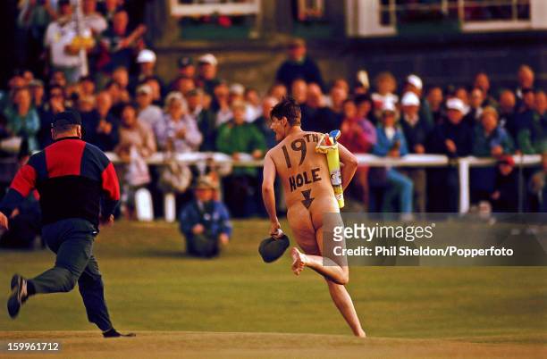Male streaker with a bag of toy golf clubs on the 18th green during the British Open Golf Championship held at St Andrews, Scotland, circa July 1995.