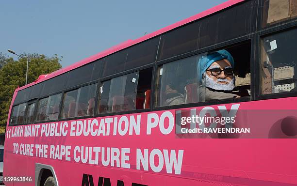 Man dressed as Indian Prime Minister Manmohan Singh sits on the 'Pink Bus' which launched the Campaign for Education as the solution to cure India's...