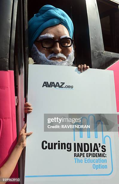 Man dressed as Indian Prime Minister Manmohan Singh stands with a placard on the 'Pink Bus' which launched the Campaign for Education as the solution...