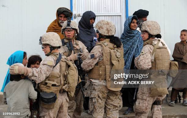 Marines 2nd Batallion,1st Marines with Female Engagement Team members speak with Afghan villagers during a visit to a village in Gamser, Helmand...