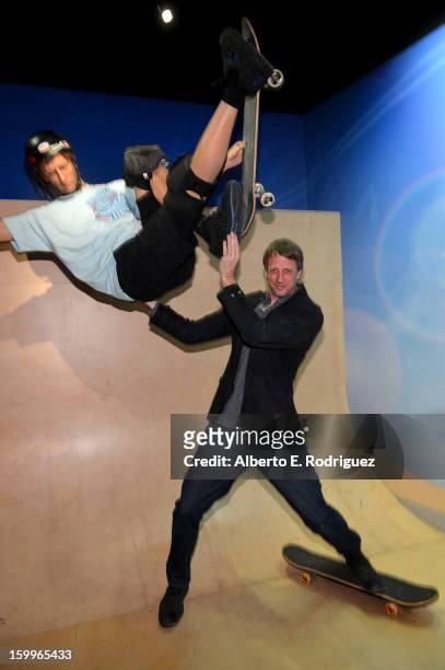 Professional skateboarder Tony Hawk poses next to a wax figure of himself as he attends Relativity Media's "Movie 43" Los Angeles Premiere After...