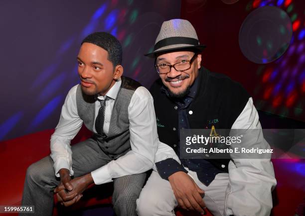 Director Rusty Cundieff poses next to a wax figure of actor Will Smith as he attends Relativity Media's "Movie 43" Los Angeles Premiere After Party...