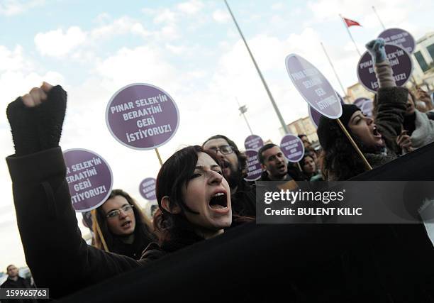 Supporters of Turkish sociologist Pinar Selek demonstrate holding signs reading 'Justice for Pinar Selek' in front of a courthouse in Istanbul on...
