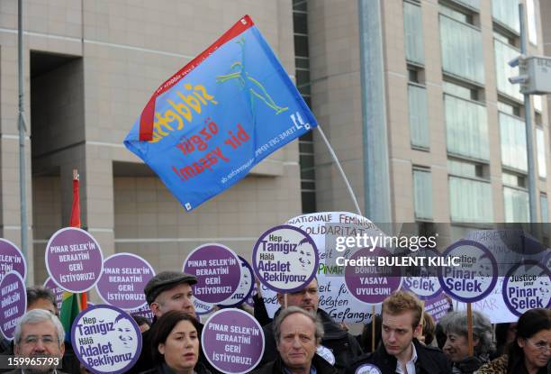 Supporters of Turkish sociologist Pinar Selek demonstrate holding signs reading 'Justice for Pinar Selek' in front of a courthouse in Istanbul on...