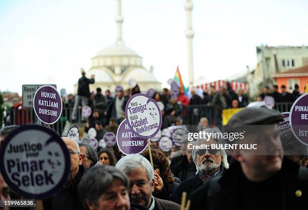 Supporters of Turkish sociologist Pinar Selek demonstrate holding signs reading 'Justice for Pinar Selek' in front of a courthouse in Istanbul on...