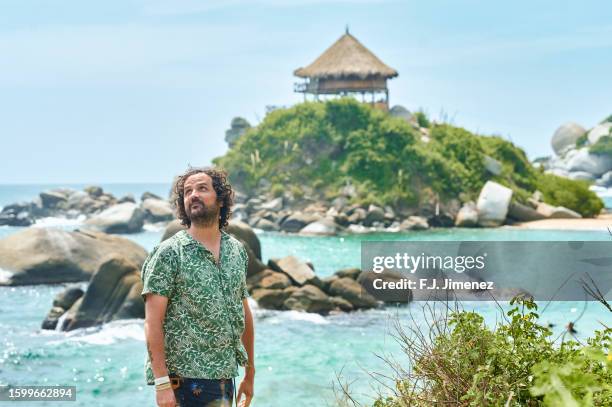 happy man in cabo san juan in tayrona national park in colombia - マグダレーナ ストックフォトと画像