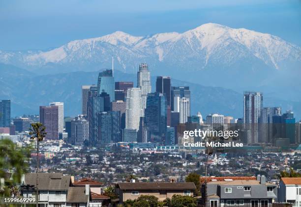 downtown los angeles skyline and snow capped mountains - la skyline stock pictures, royalty-free photos & images